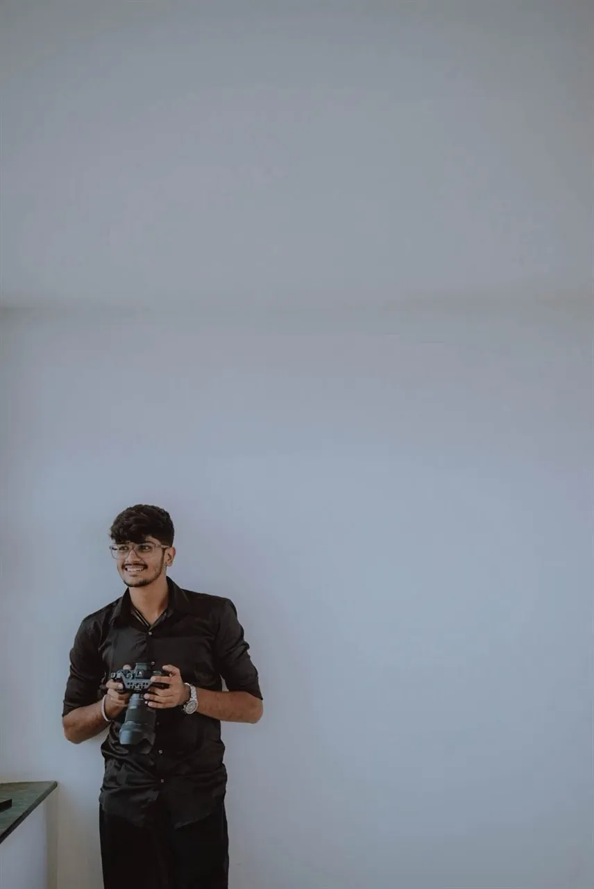 A photographer of the team at Shobha Digital Studio, holding a camera